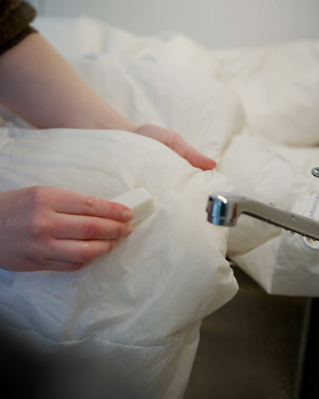 A stain soap being used to wash a down duvet