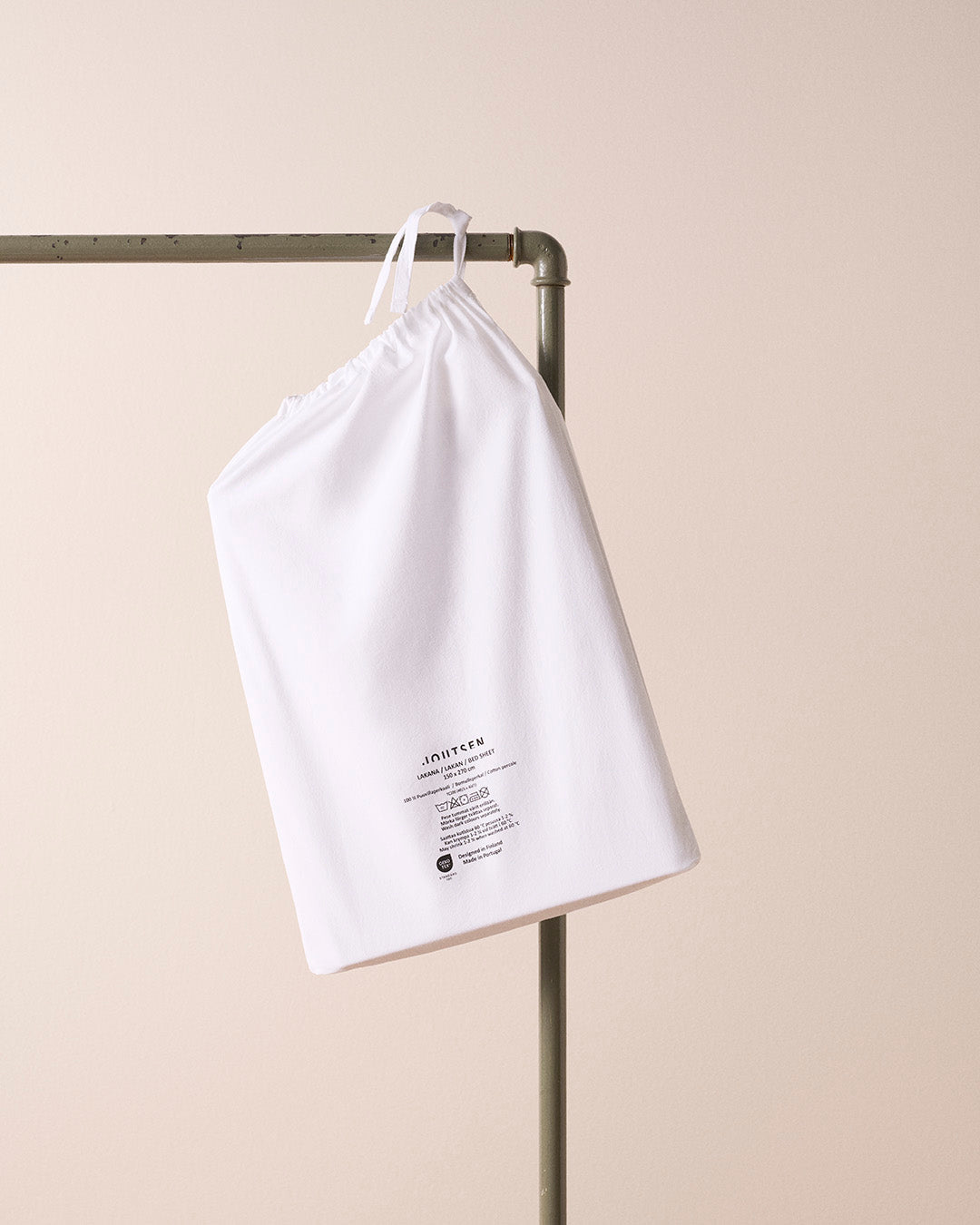 White drawstring bag with text on a beige background