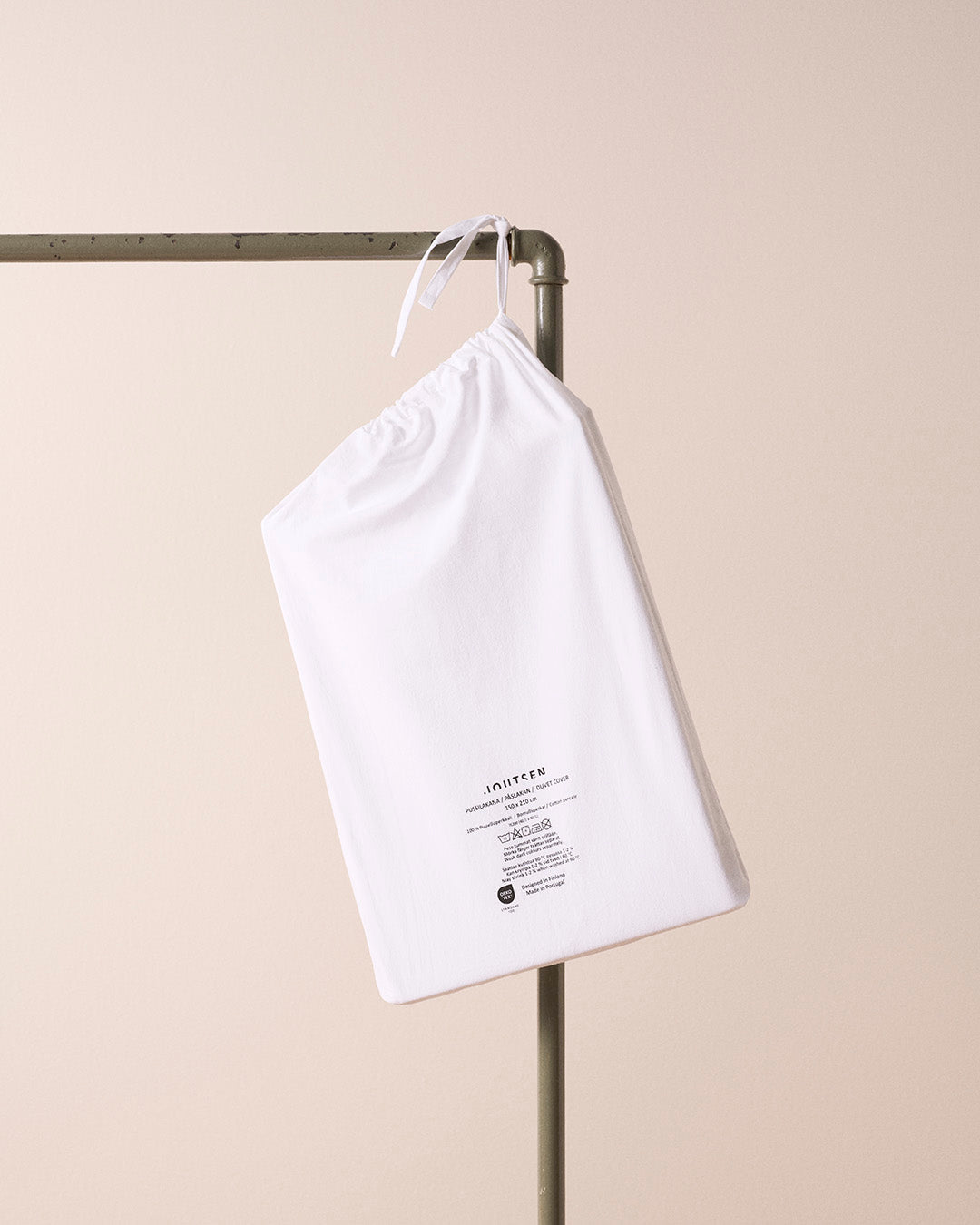 White drawstring bag with text on a beige background